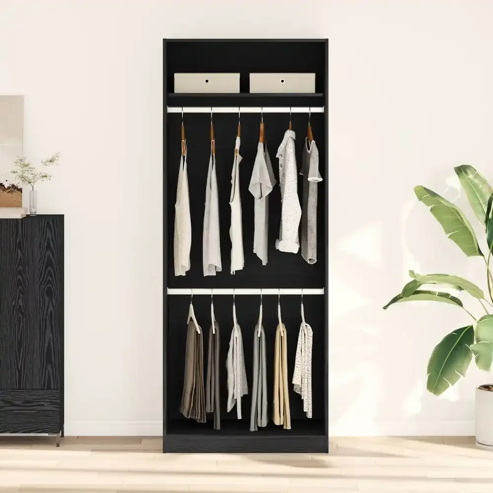 Black standing dressing cabinet with hanging rods and top storage for clothing