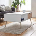 Angled view of white MDF coffee table with central shelf and wood-look drawer