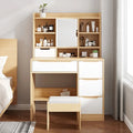 Light wood dressing table with flip-top mirror, open shelves, and drawers with pulls