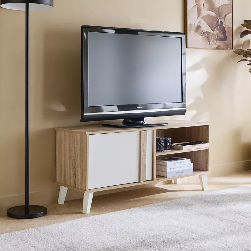 TV stand with TV centered; light wood base, white door at left and open storage at right