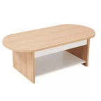 Light wood oval coffee table with white base panel and lower storage shelf.