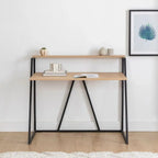 Rectangular desk with light wood top, black metal A-frame supports, and two-tier shelf.