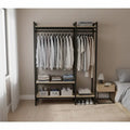 Clothes stand with dark metal frame, hanging shirts, and lower fabric storage shelves