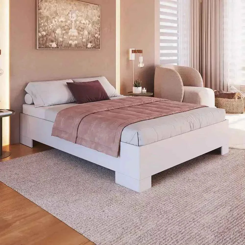 White MDF bed frame with upholstered headboard, pillows and duvet