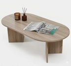 Light wood MDF coffee table with oval tabletop and tapered side supports