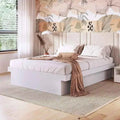 White MDF bed with tall slatted headboard, pillows and taupe throw blanket