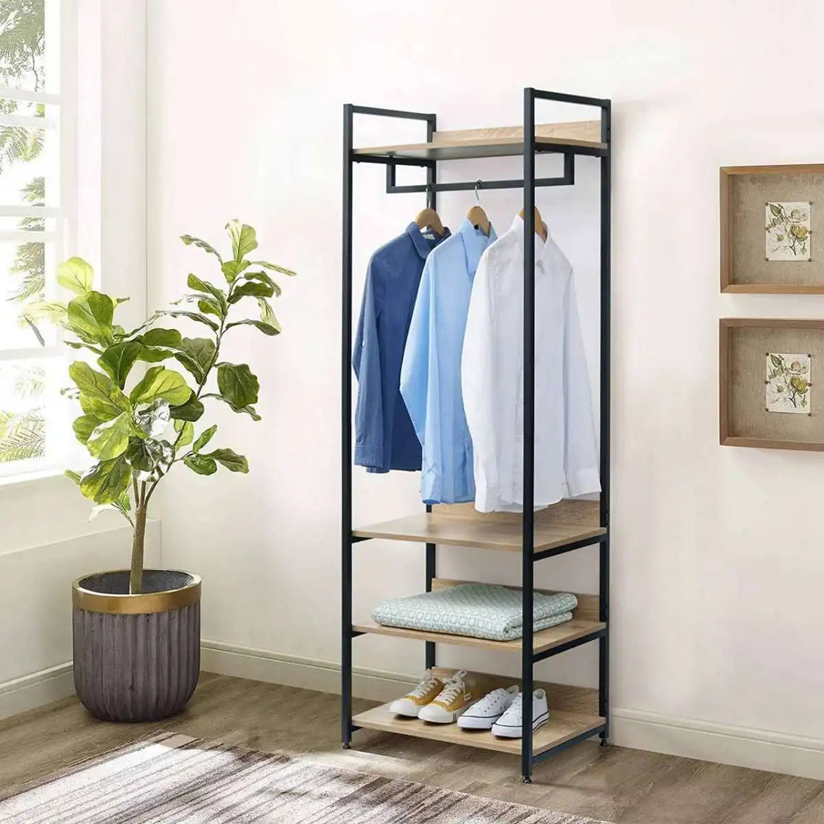 Black metal clothes stand with MDF shelves and top hanging bar, holding shirts and pants