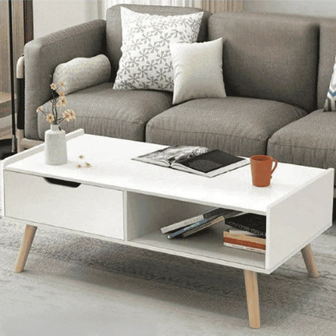 White MDF coffee table with drawer and open shelf, light wood legs, 100x50x40cm