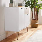 White coffee cabinet with oak-tone drawer fronts, two doors, and angled wooden legs