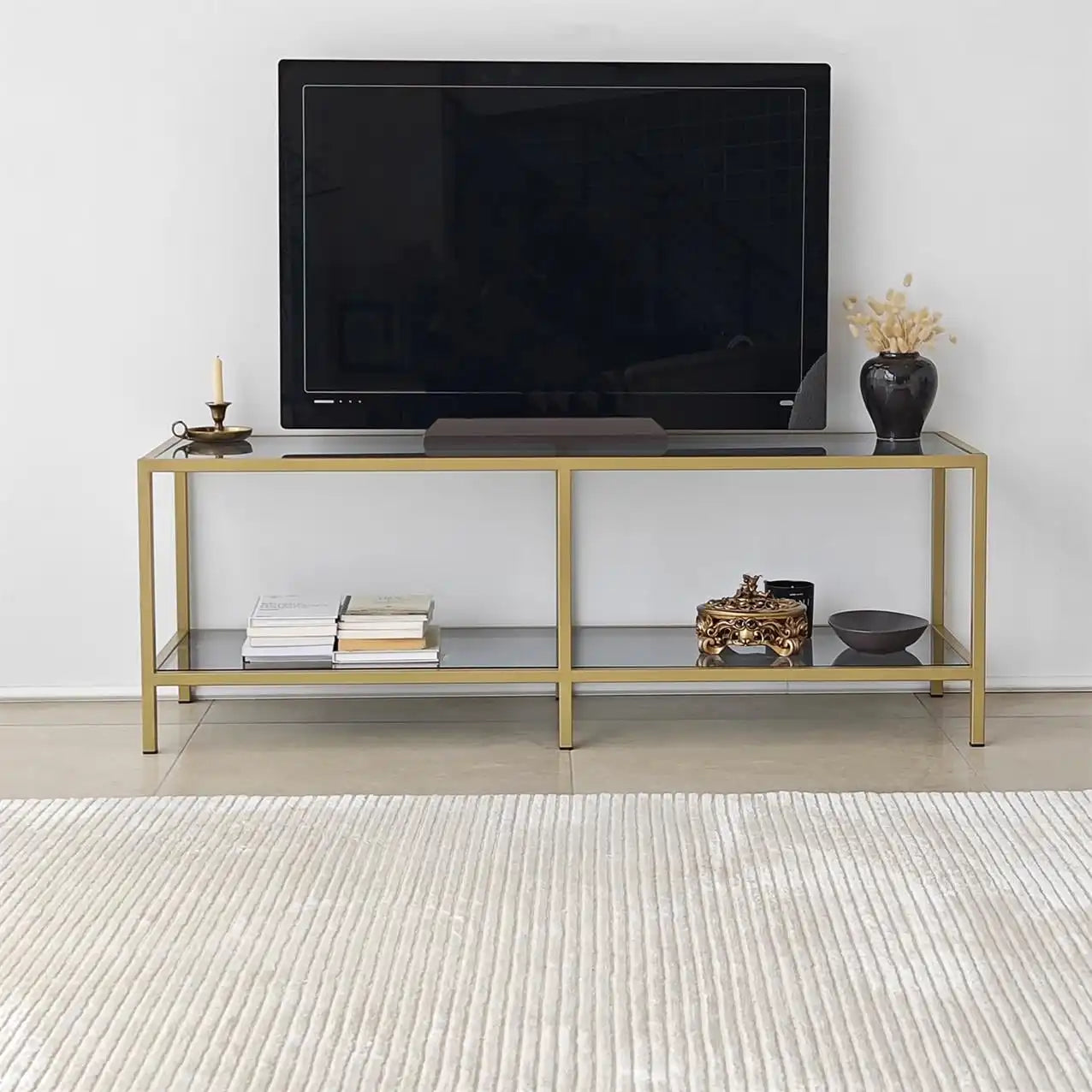 Front view TV stand: black panel top, gold frame, two open shelves for electronics