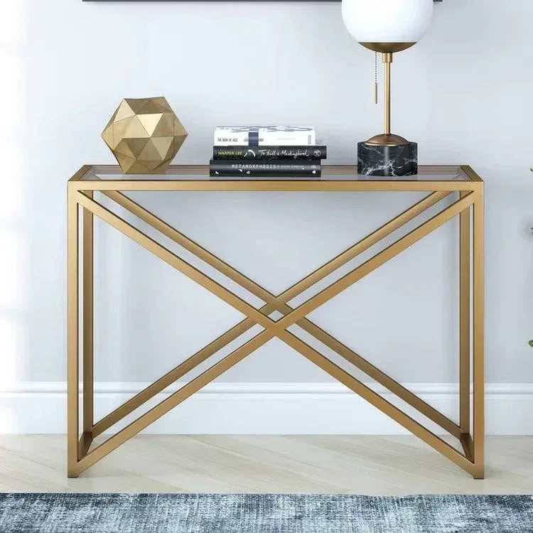 Gold metal console table with glass shelf and X-cross frame